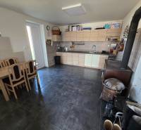 Küche in einem Einfamilienhaus mit Küchenzeile, Esstisch und Herd.