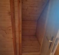 Innenraum aus Holz in einer Hütte mit Holzdekor und Treppe.