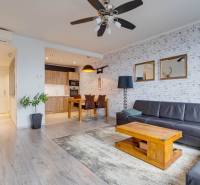 Wohnzimmer in einer 3-Zimmer-Wohnung mit Holzboden und Ledersofa.