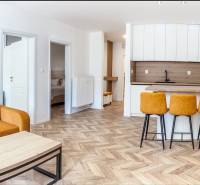 Ferienwohnung mit Sofa, Küchentheke und Holzboden.