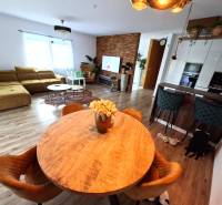 Wohnzimmer in einem Einfamilienhaus mit Sofa, Esstisch und Holzboden.