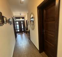 Flur im Einfamilienhaus mit Holzboden und dekorativem Spiegel an der Wand.