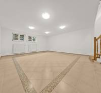 Innenraum mit Keramikfliesen, Treppe und Heizkörpern in einem Einfamilienhaus.