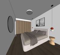 Schlafzimmer in einer 2-Zimmer-Wohnung mit Holzboden und grauen Wänden.