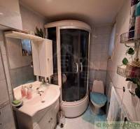 Badezimmer in einem Einfamilienhaus mit moderner Dusche, Waschbecken und Toilette.