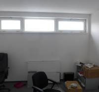 Ein Raum mit einem Fenster und Bürostühlen in Geschäftsräumen.