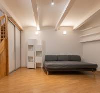 Wohnzimmer mit Sofa, Treppe und Holzboden in einer 4-Zimmer-Wohnung.