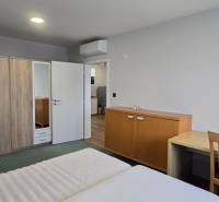 Schlafzimmer in einer 3-Zimmer-Wohnung mit Doppelbett, Schrank und Tisch.