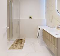 Badezimmer mit Waschmaschine, Dusche, Waschbecken und Spiegel in einer Einzimmerwohnung mit Marmordetails.