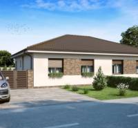 Ein Einfamilienhaus in Veľké Dvorníky mit Ziegelverkleidung und einem Auto in der Garage.