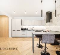 Küche in einer 4-Zimmer-Wohnung mit Holzboden und stilvollen Leuchten.