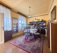 Esszimmer in einem Einfamilienhaus mit Holzboden, dekoriertem Teppich und Tisch.