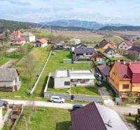Einfamilienhäuser in der Bošianska-Straße in Neporadza, umgeben von Grün und Gebirgen.