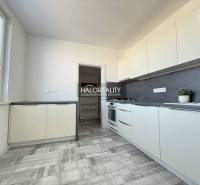 Küche in einer 2-Zimmer-Wohnung mit Holzboden und hellen Möbeln.