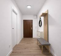 Der Flur einer 2-Zimmer-Wohnung mit einem Boden in Holzoptik, einem Spiegel und einer Bank.