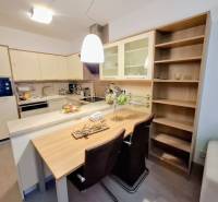 Küchenbereich in einer 2-Zimmer-Wohnung mit Bartresen und Einbauschränken.