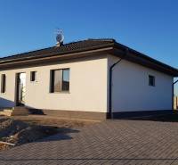 Einfamilienhaus in der Jelšová-Straße in Bernolákovo mit weiß-grauer Fassade und Hof.