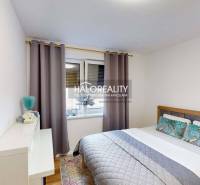 Schlafzimmer mit Bett und Fenster, Teil einer 3-Zimmer-Wohnung.