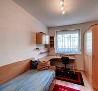 Ein Zimmer in einer 3-Zimmer-Wohnung mit Bett, Schreibtisch und Holzboden.