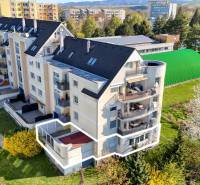 Ein Gebäude mit einer 3-Zimmer-Wohnung in der E. Belluš-Straße in Piešťany, umgeben von Grün.