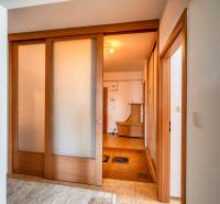 Innenraum einer 3-Zimmer-Wohnung mit Schiebetüren und einem Boden in Holzoptik.