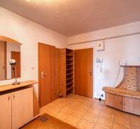 Diele in einer 3-Zimmer-Wohnung mit Fliesen, einem Einbauschrank und Holzmöbeln.