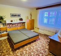 Ein Zimmer in einer 3-Zimmer-Wohnung mit Holzmöbeln und einem Teppich auf dem Boden.