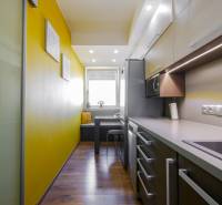 Küche in einer 3-Zimmer-Wohnung mit Holzboden und gelben Wänden.