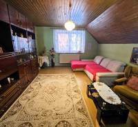 Wohnzimmer mit Teppich, Sofa und Holzboden in einem Einfamilienhaus.