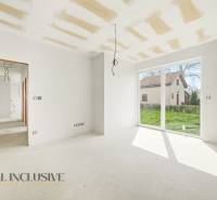 Helles Zimmer in der Hütte mit großen Fenstern und Blick in den Garten.