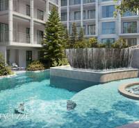 Ein Pool und ein Whirlpool, umgeben von Grünflächen, beim Bau von Wohnungen in Phuket.