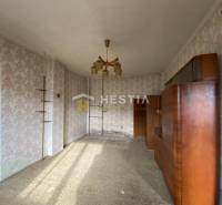 Innenraum eines Einfamilienhauses mit Retro-Tapeten und einer hölzernen Wohnwand.