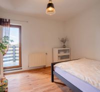Helles Schlafzimmer in einer 4-Zimmer-Wohnung mit Holzboden, Pflanze und Balkon.
