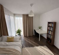 Innenraum eines Einfamilienhauses mit einem hellen Zimmer, einem Bett und einem Boden mit Holzdekor.