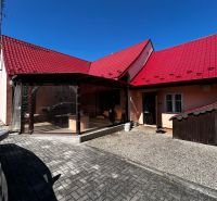 Ein Einfamilienhaus in Lakšárska Nová Ves in Mikulášov mit einem roten Dach und einem gepflasterten Hof.