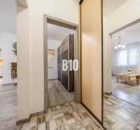 Innenraum einer 2-Zimmer-Wohnung mit Holzboden, hellem Mobiliar und bogenförmigen Durchgängen.