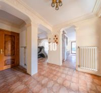 Flur in einem Einfamilienhaus mit verziertem Decke und braunen Türen.