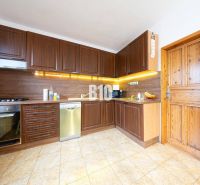 Küche mit Holzschränken, Boden mit Holzdekor in einem Einfamilienhaus.