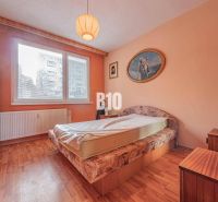 Schlafzimmer in einer 3-Zimmer-Wohnung mit Bett, Schrank und Boden in Holzoptik.