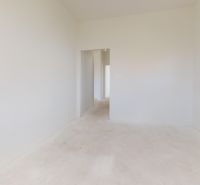 Ein neutraler Innenraum mit weißen Wänden und einem Fenster in einem Einfamilienhaus.