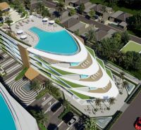 Wohnungsbau in Phuket mit Pools auf dem Dach und tropischem Grün.