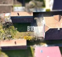 Ein Blick auf das Einfamilienhaus in Turany mit einem weitläufigen Garten und einem Gewächshaus.