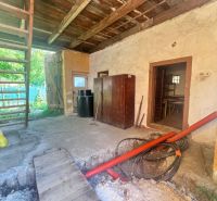Das Innere eines Einfamilienhauses mit Holzbalkendecke, aufgerissenem Boden und einer Leiter.