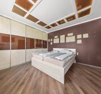 Schlafzimmer in einem Einfamilienhaus mit Holzboden und Einbauschrank.