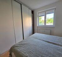 Schlafzimmer mit Einbauschrank und Fenster in einer 2-Zimmer-Wohnung.