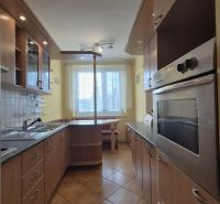 Küche mit Küchenzeile in einer 4-Zimmer-Wohnung, Boden mit Holzdekor.