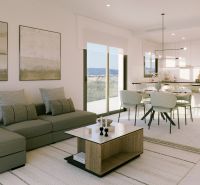 Heller Wohnbereich einer Ferienwohnung mit Sofa und Esstisch.
