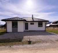 Ein Einfamilienhaus in Ižipovce mit einer einfachen Fassade und einem schrägen Dach auf einem sonnigen Grundstück.