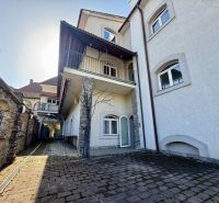 Ein Herrenhaus mit besonderen Immobilien in Banská Bystrica mit Steindetails und Bordsteinpflaster.