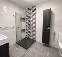 Badezimmer mit moderner Duschkabine und Fliesen in einer 3-Zimmer-Wohnung.